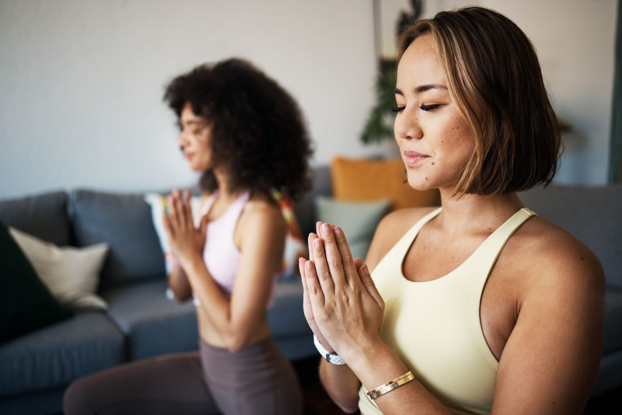 two woman meditating to achieve their goal of a 'New Year New Me'
